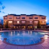 a large building with a pool in front of it