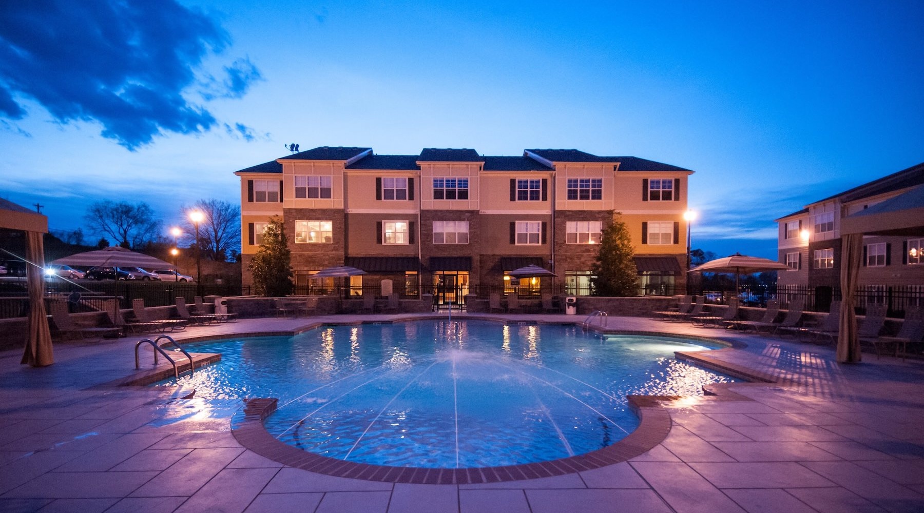 a large building with a pool in front of it