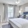 a bedroom with a bed and a fan
