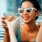 a woman in a pool holding a drink and a glass