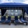 a group of blue chairs under a blue awning
