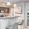 a kitchen with a bar and chairs