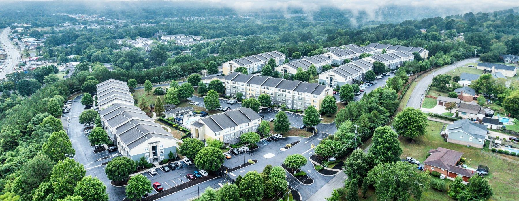 a large building with trees and roads