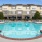 a swimming pool in front of a building