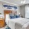 a bedroom with a bed and a fan